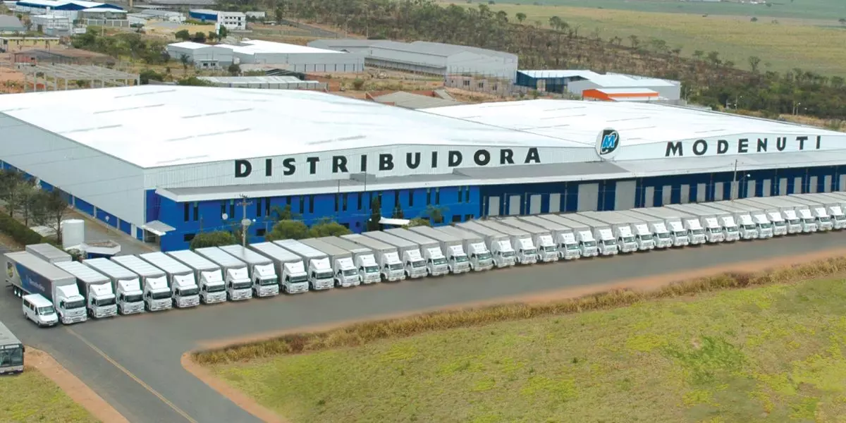 A foto mostra a Distribuidora Modenuti e sua frota de caminhões