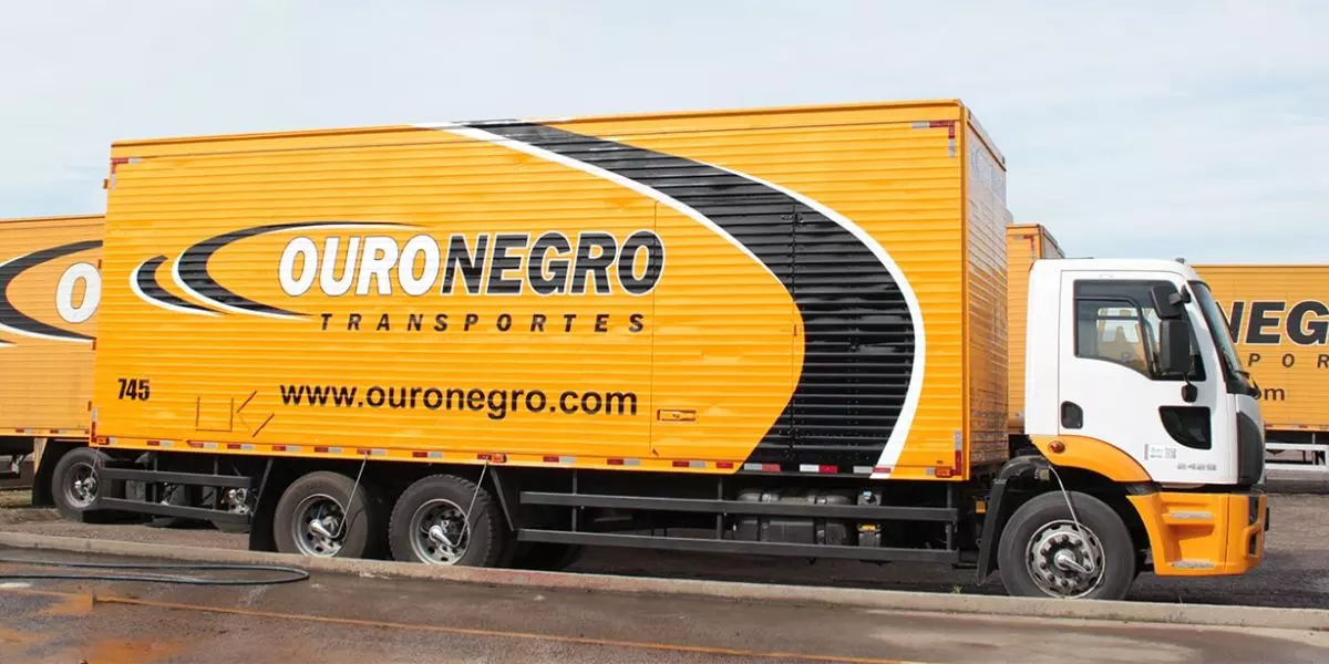 A foto mostra caminhões da Ouro Negro Transportes